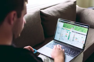 A cheerful woman in traditional clothing using her smartphone during a festive moment, showing how easily the SOUL777 app fits into everyday life.